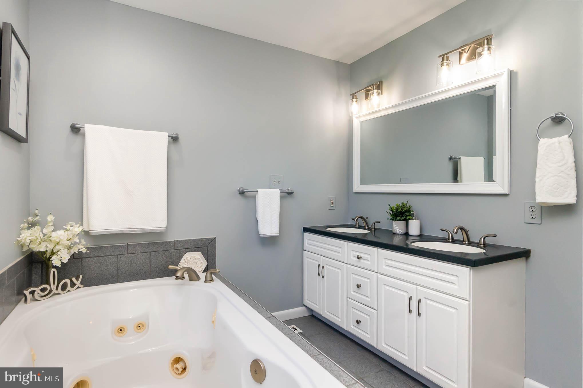 409 Fieldstone Court Fallston, MD 21047 - Photo 23 of 53 a bathroom with a tub sink and mirror
