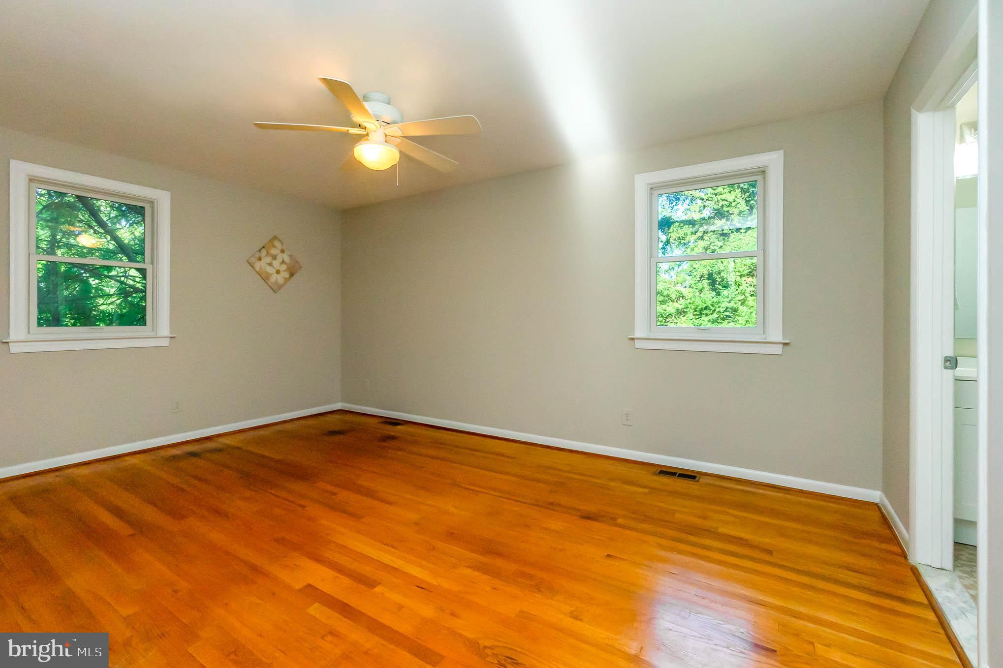 409 Fieldstone Court Fallston, MD 21047 - Photo 24 of 53 a view of an empty room with wooden floor and a window