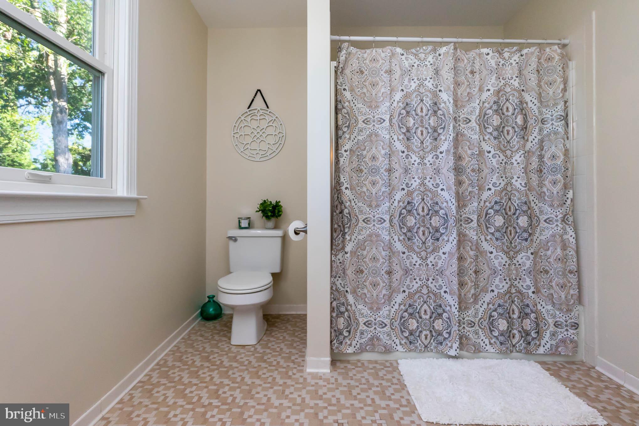 409 Fieldstone Court Fallston, MD 21047 - Photo 27 of 53 a bathroom with a toilet and a shower curtain