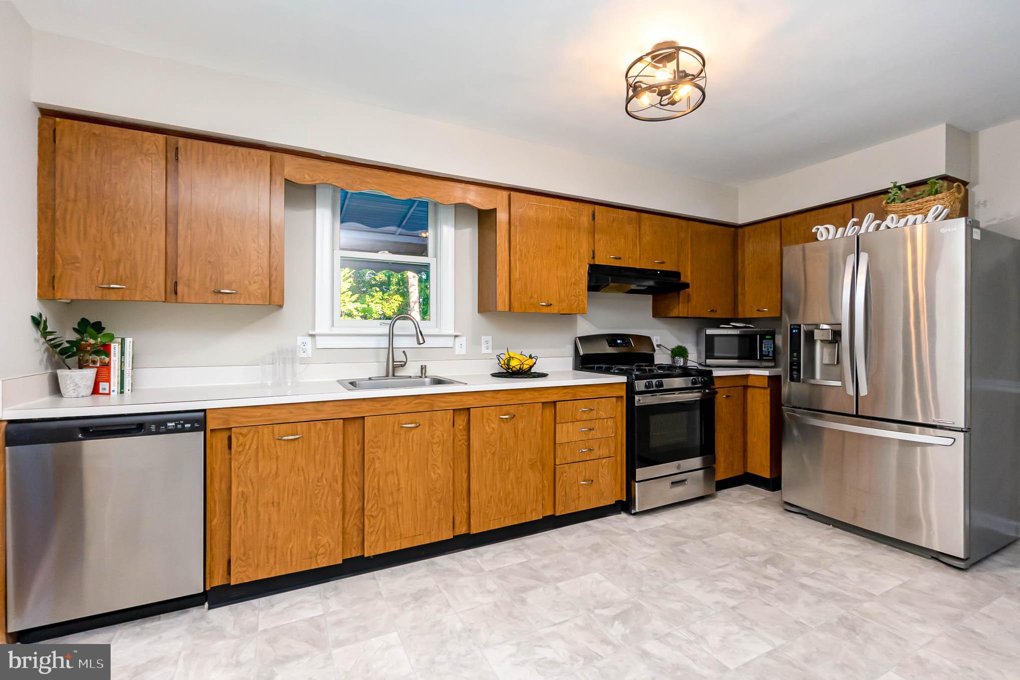 409 Fieldstone Court Fallston, MD 21047 - Photo 9 of 53 a kitchen with granite countertop stainless steel appliances a stove a sink a refrigerator and a window
