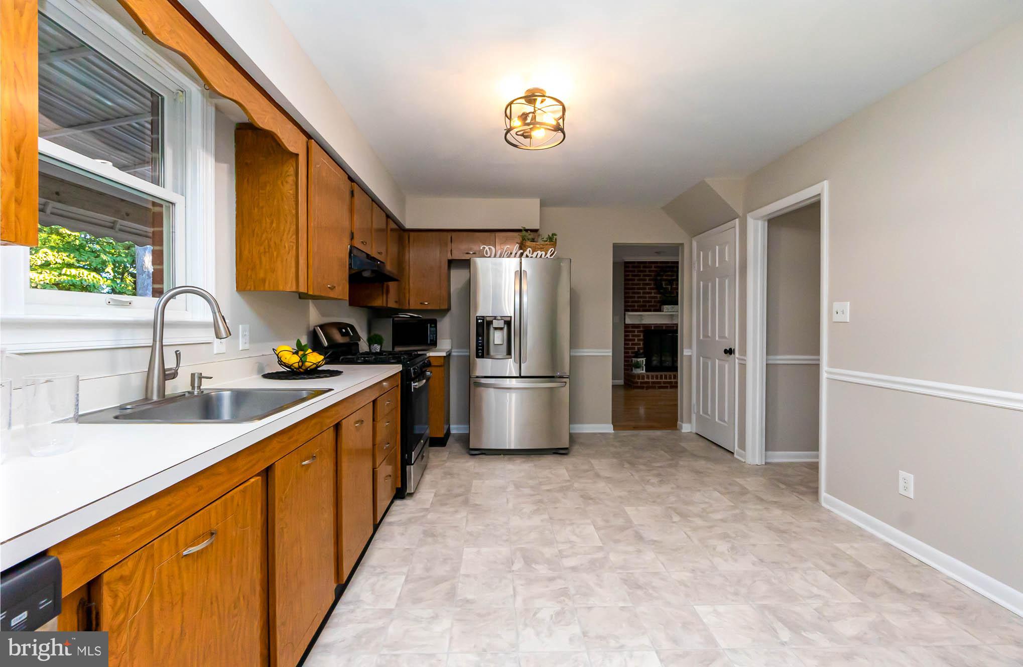 409 Fieldstone Court Fallston, MD 21047 - Photo 10 of 53 a kitchen with stainless steel appliances a sink cabinets and a refrigerator