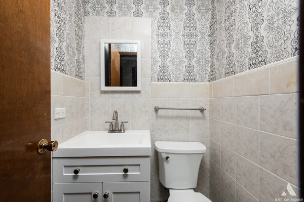 a bathroom with a sink a toilet and mirror