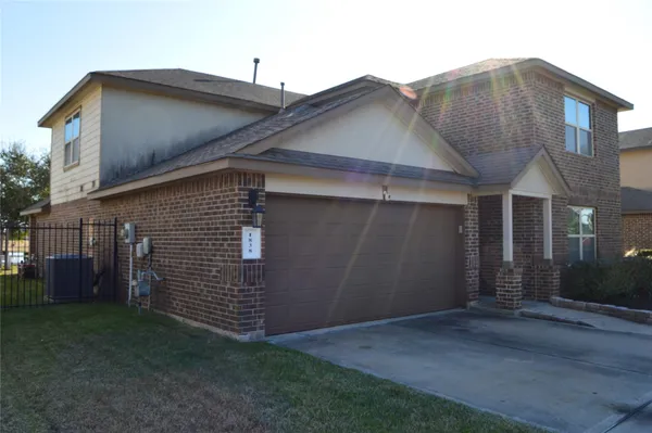 a view of a house with brick walls