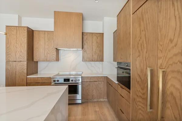 a kitchen with stainless steel appliances a refrigerator sink and stove