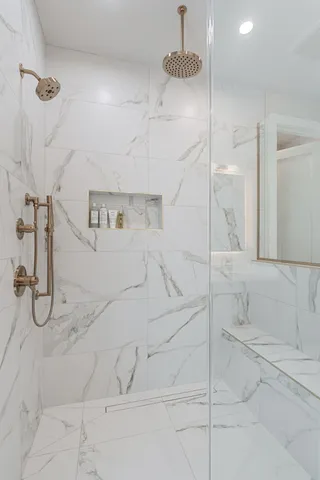 a bathroom with a double vanity sink mirror and shower