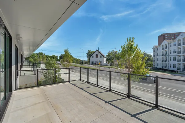 a view of a balcony with outdoor seating