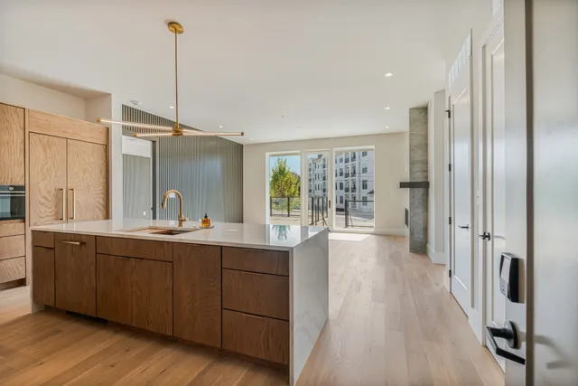 a view of a kitchen with a sink and wooden floor