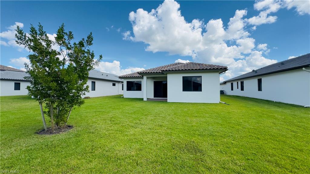 5105 Penella Ave Ave Avenue Immokalee, FL 34142 - Photo 16 of 37 a front view of a house with garden