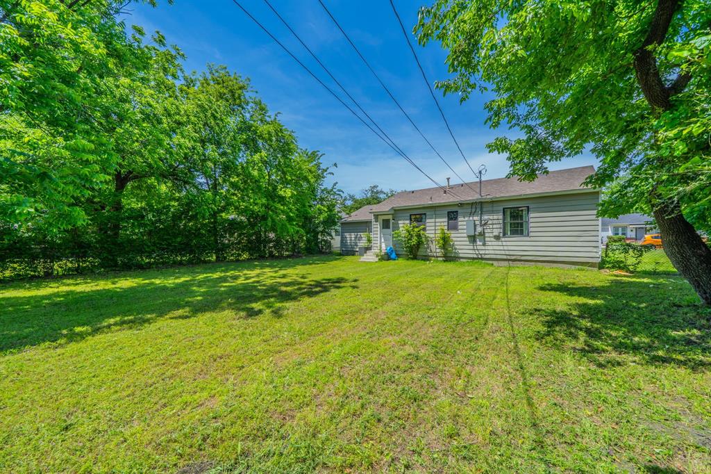 11528 Sinclair Avenue Dallas, TX 75218 - Photo 15 of 16 Expansive green lawn with mature perimeter trees