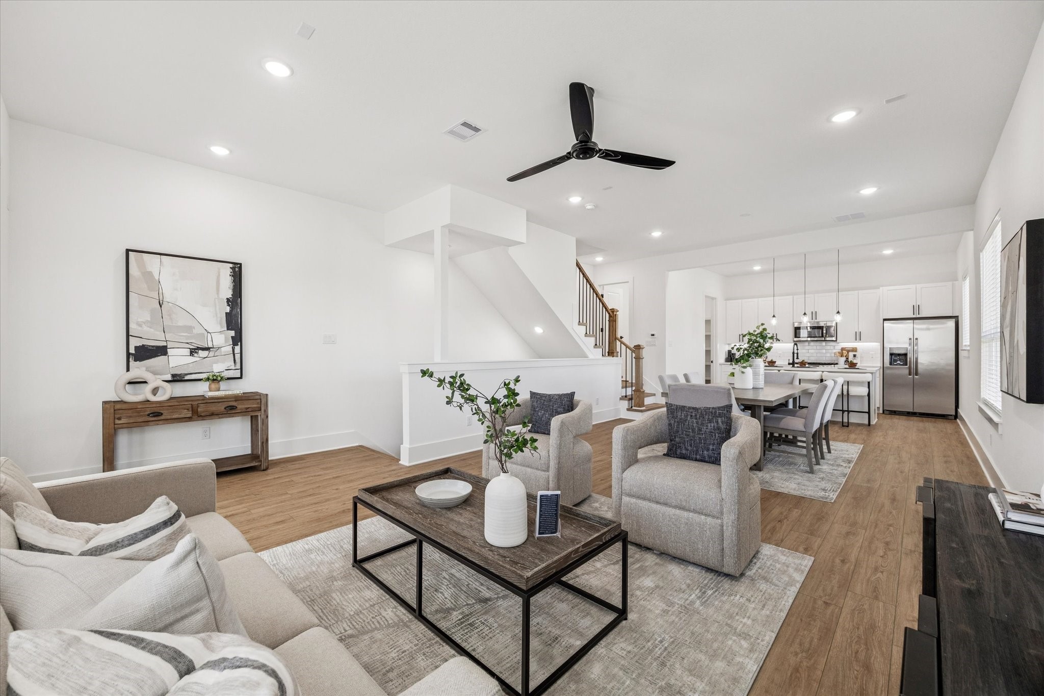 a living room with furniture and kitchen view