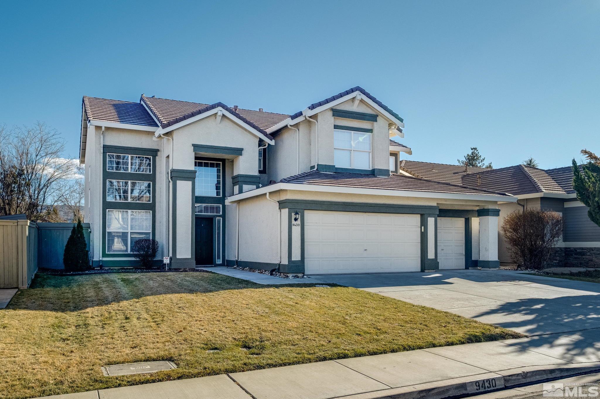 9430 Oakley Lane Reno, NV 89521 - Photo 1 of 28 a front view of a house with a yard