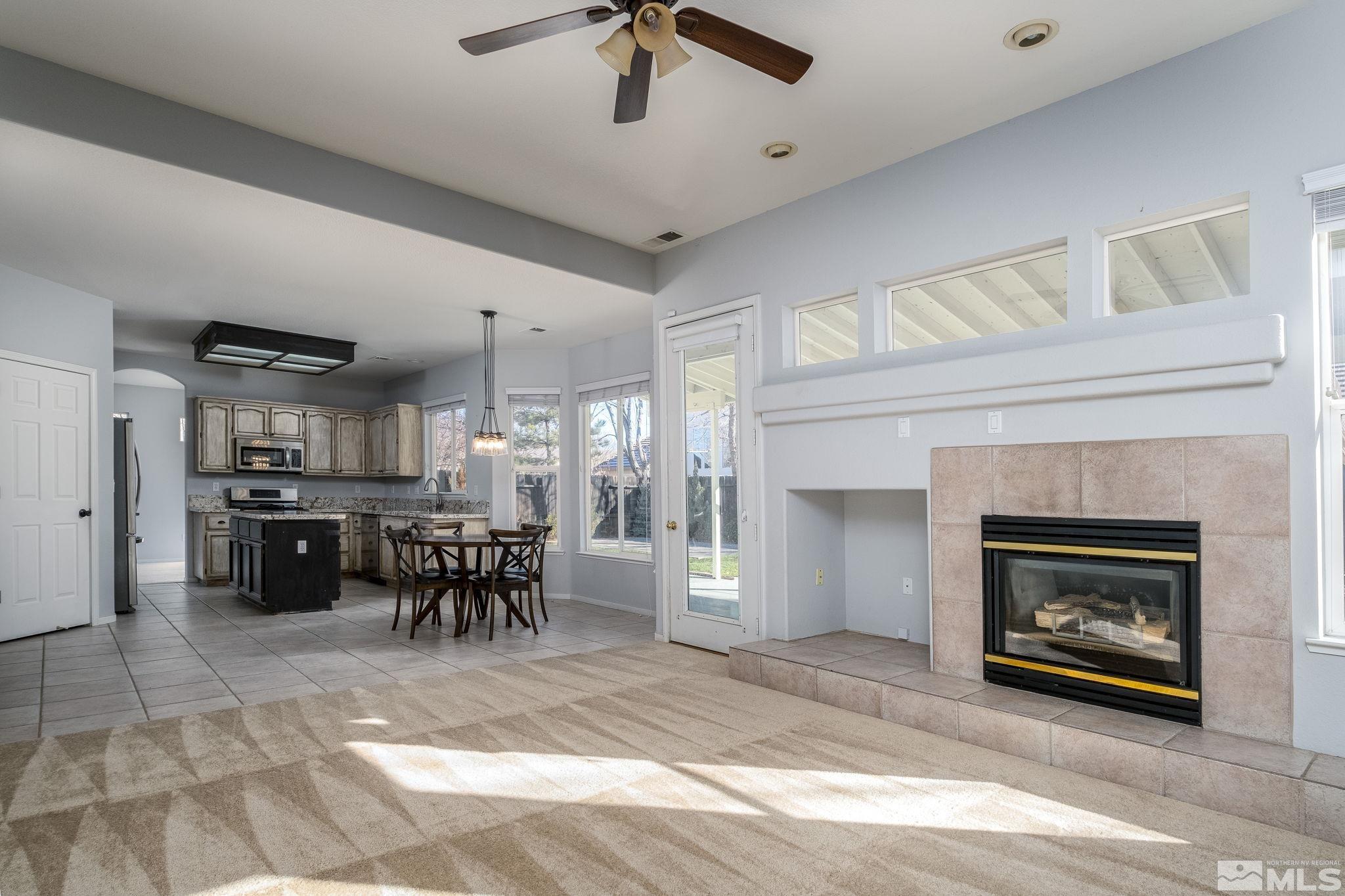 9430 Oakley Lane Reno, NV 89521 - Photo 14 of 28 a dining room with furniture and a fireplace