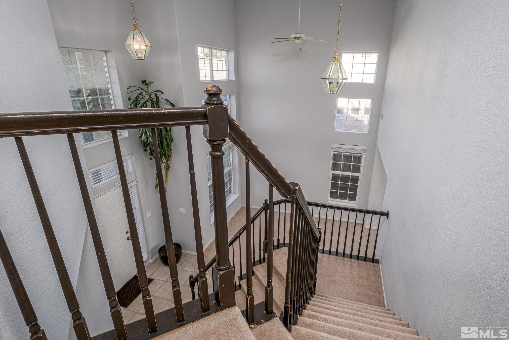 9430 Oakley Lane Reno, NV 89521 - Photo 16 of 28 a view of a hallway with wooden floor and staircase