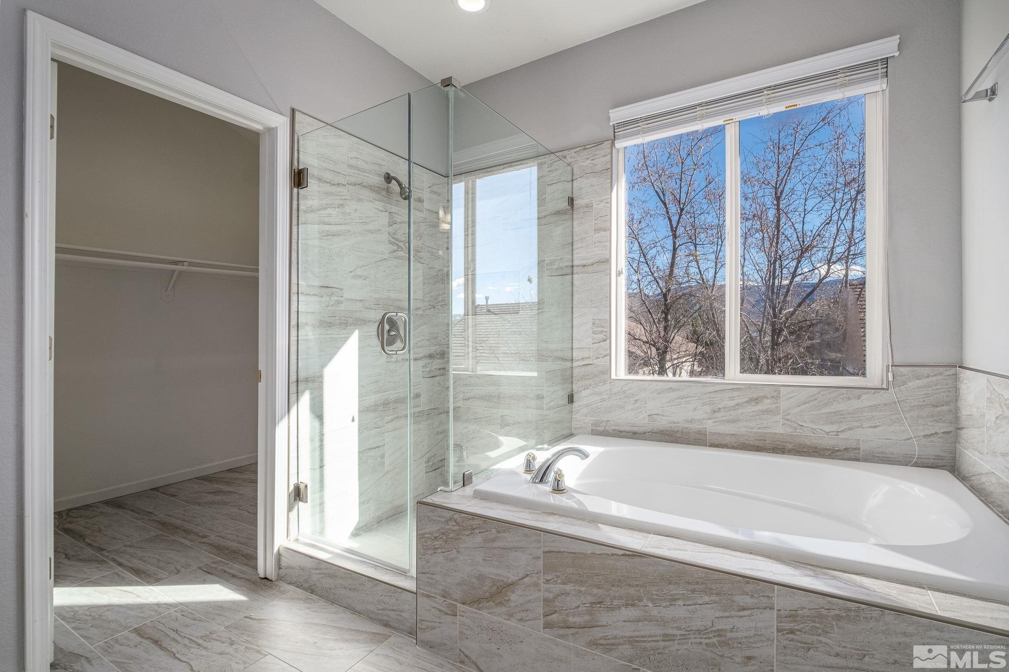 9430 Oakley Lane Reno, NV 89521 - Photo 23 of 28 a bathroom with a bathtub and a shower