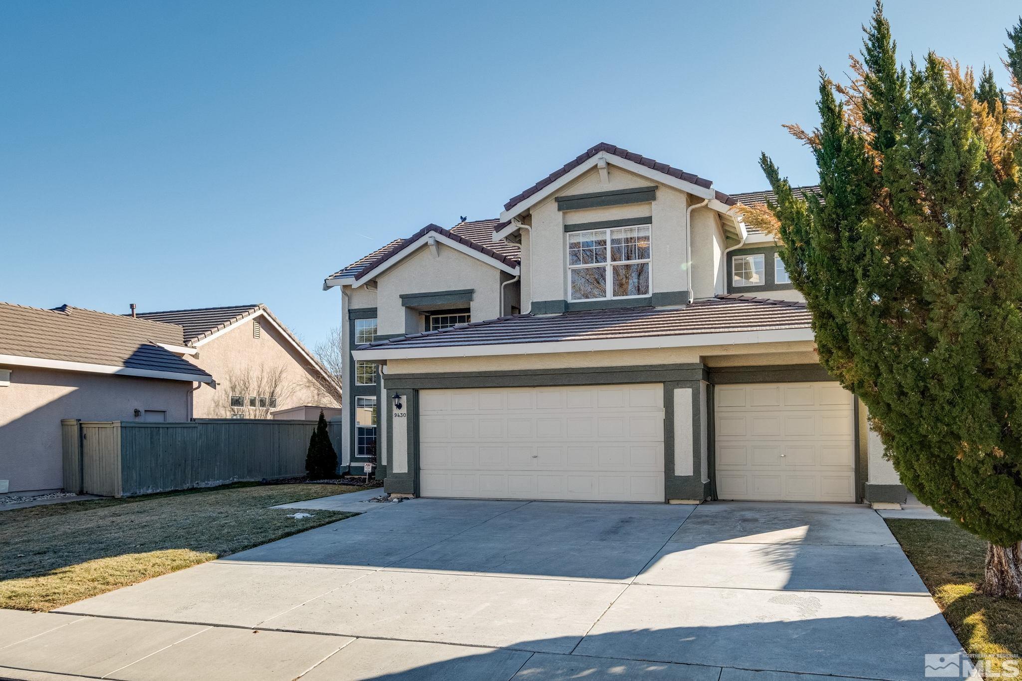 9430 Oakley Lane Reno, NV 89521 - Photo 3 of 28 a front view of a house with a yard and garage