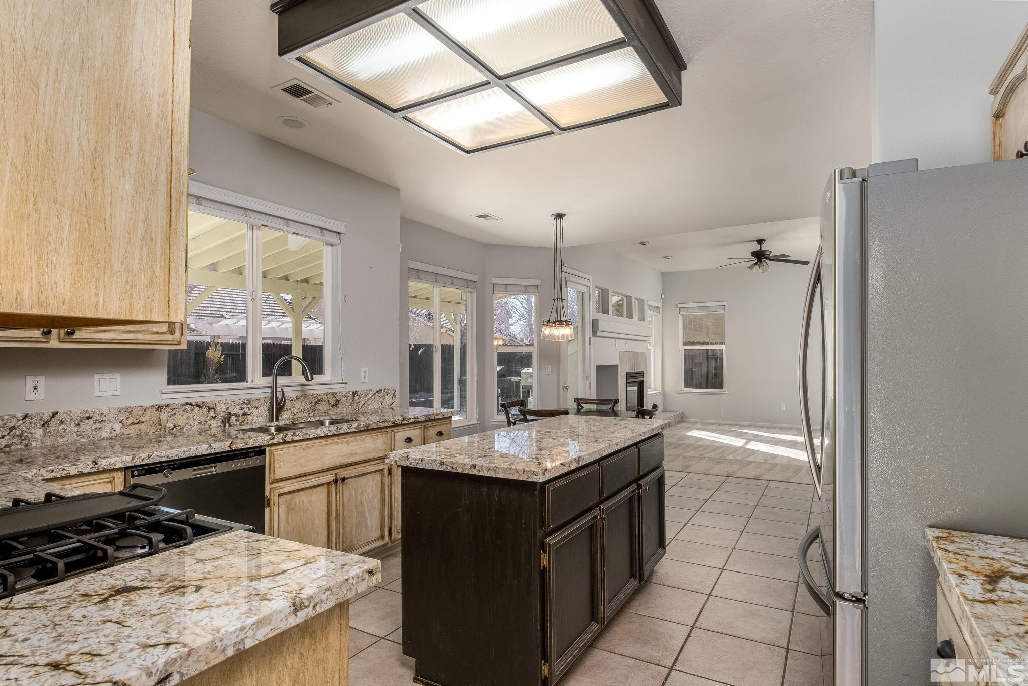 9430 Oakley Lane Reno, NV 89521 - Photo 8 of 28 a kitchen with a sink stove and refrigerator