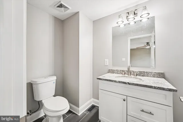 a bathroom with a sink toilet and mirror