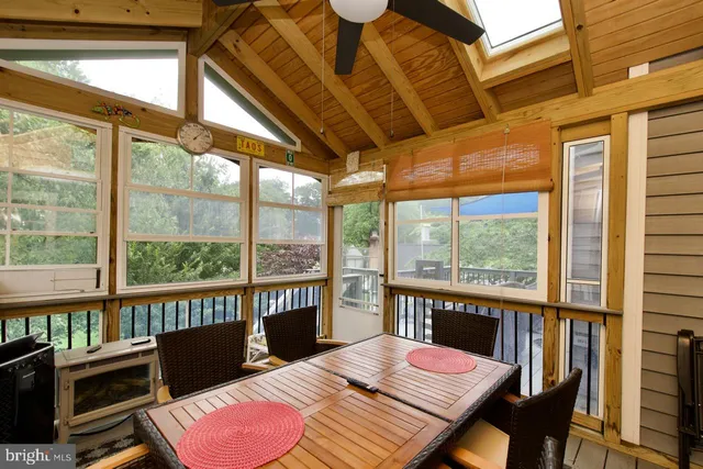 a bedroom with furniture and a large window