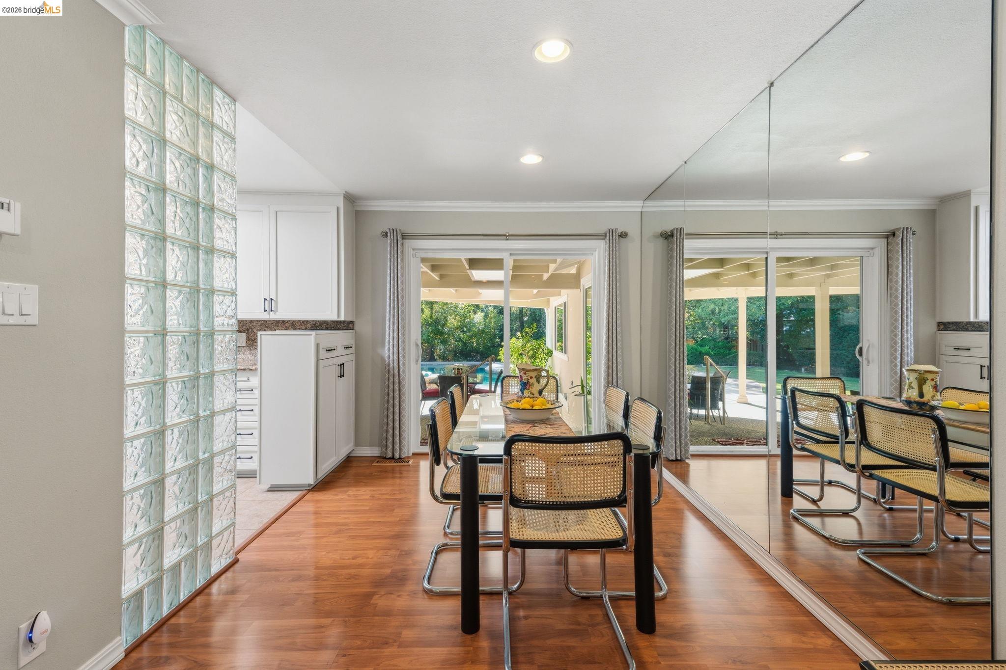 5075 Alhambra Valley Road Martinez, CA 94553 - Photo 10 of 68 Wood-finish flooring throughout, full-height mirrored wall, glass block partition, recessed lighting, and sliding glass doors to the exterior