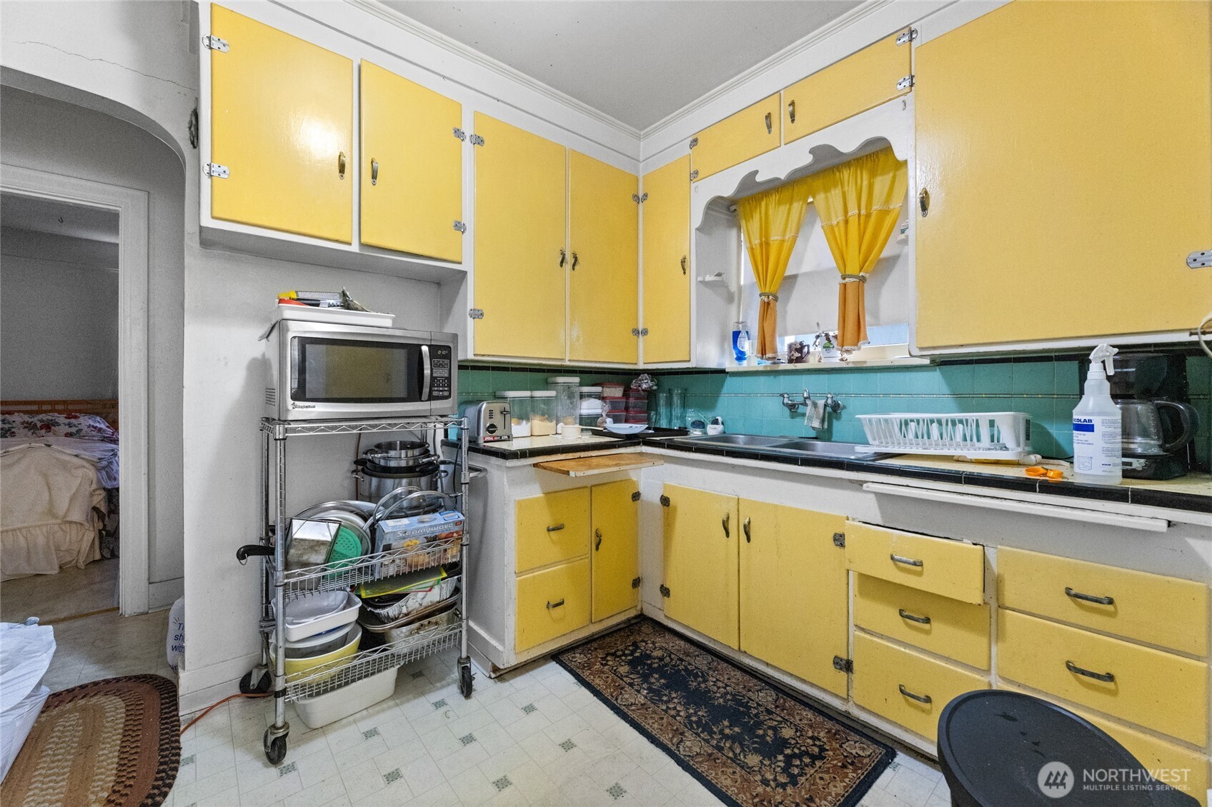 4830 South C Street Tacoma, WA 98408 - Photo 5 of 22 a kitchen with stainless steel appliances a stove a sink cabinets and a window