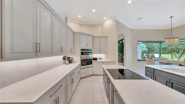 a kitchen with a sink a window and cabinets