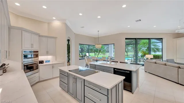 a kitchen with stainless steel appliances granite countertop a stove a sink a refrigerator and a refrigerator