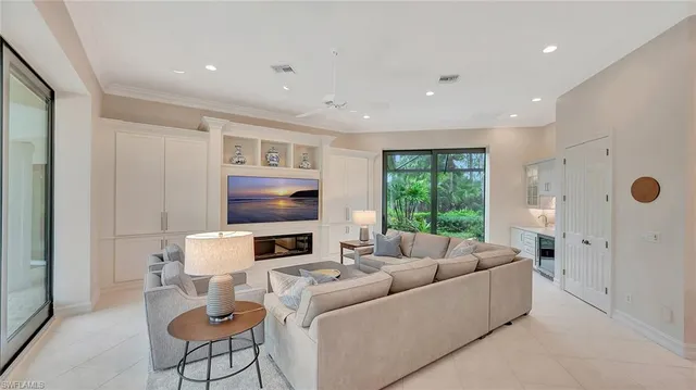 a living room with furniture fireplace and a large window