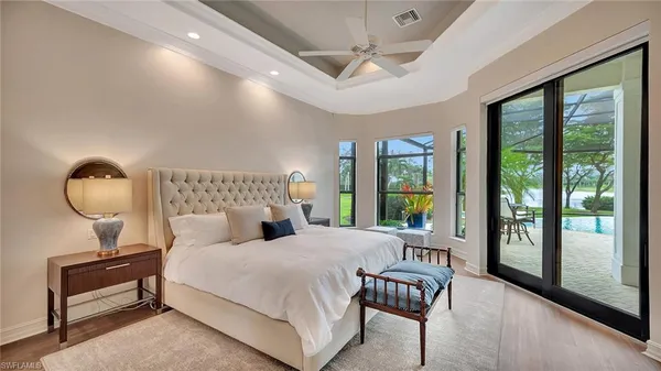 a bedroom with furniture and a large window