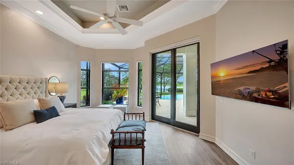 a bedroom with a bed and glass door
