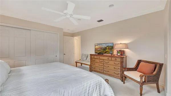 a bedroom with a bed and chair
