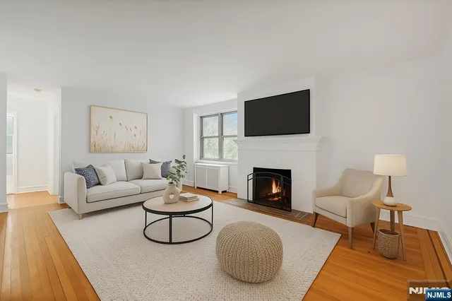 a living room with furniture a fireplace and a flat screen tv