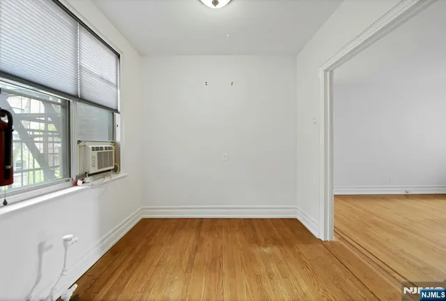 a view of a room with wooden floor and a window