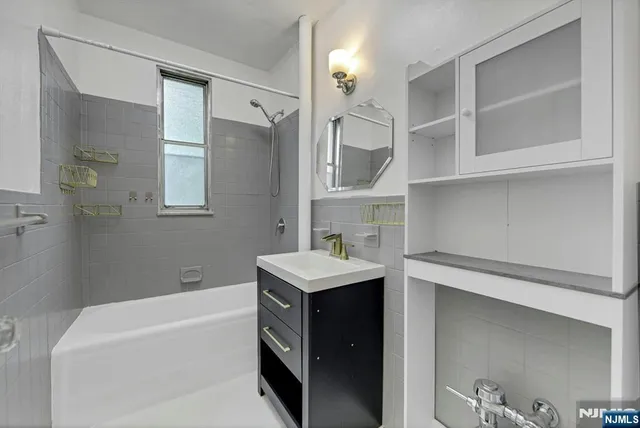 a bathroom with a sink a bathtub and a shower