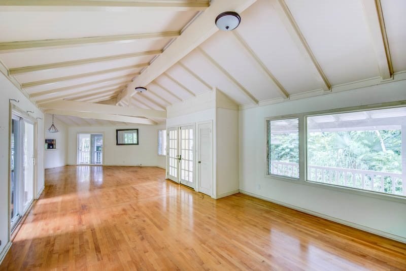 6388 Puupilo Road, Unit 2 Kapaa, HI 96746 - Photo 3 of 21 a view of an empty room with wooden floor and a window