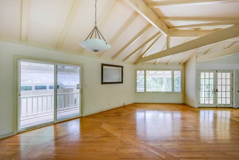 6388 Puupilo Road, Unit 2 Kapaa, HI 96746 - Photo 4 of 21 a view of an empty room with wooden floor and a window