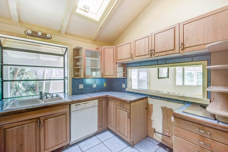 6388 Puupilo Road, Unit 2 Kapaa, HI 96746 - Photo 6 of 21 a kitchen with granite countertop white cabinets and white appliances