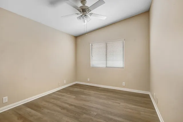 wooden floor in an empty room with a window