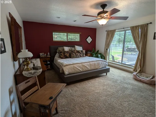 a bedroom with a bed window and dresser