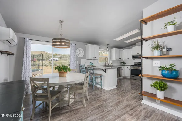 a kitchen with granite countertop a refrigerator stove top oven and sink