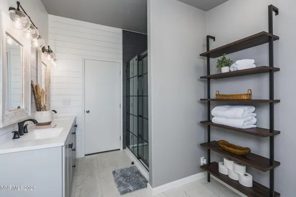 a bedroom with a bed a table and painting on the wall