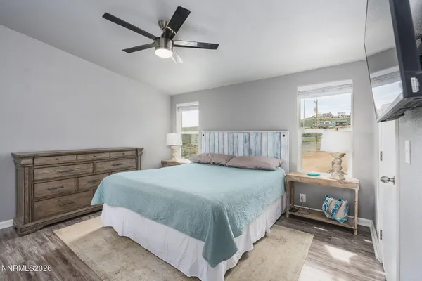a bathroom with a granite countertop sink a mirror and a bathtub