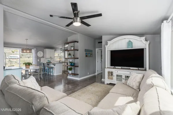 a kitchen with stainless steel appliances a dining table a stove and a refrigerator with wooden floor