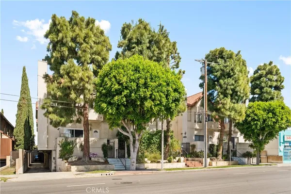 front view of a building with a tree