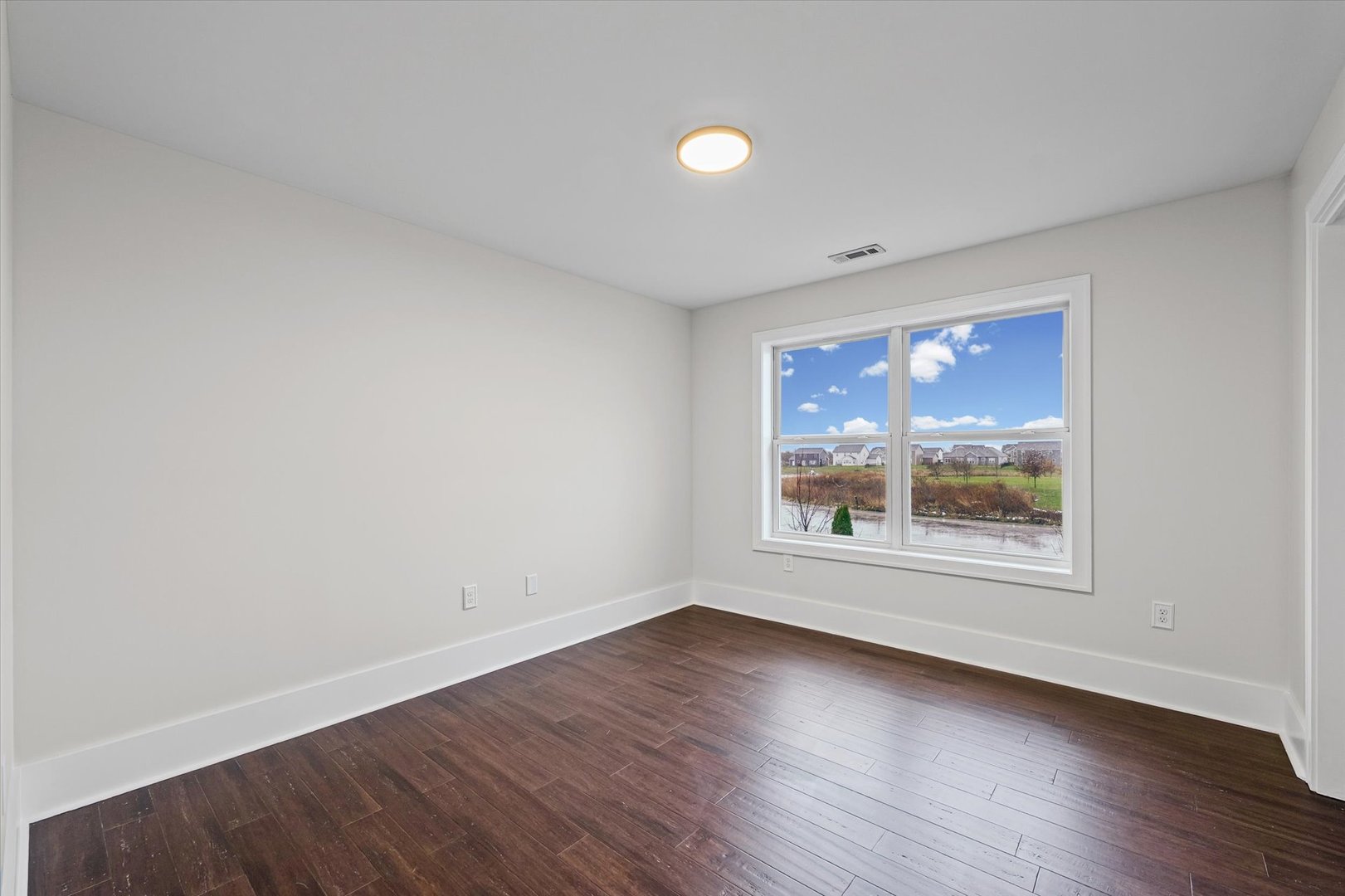 313 London Way Savoy, IL 61874 - Photo 39 of 85 an empty room with wooden floor and windows