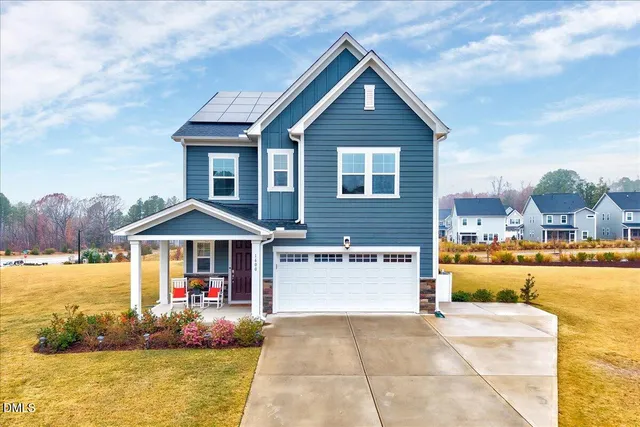 a front view of a house with swimming pool having outdoor seating