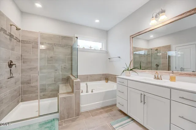 a spacious bathroom with a granite countertop sink and a mirror