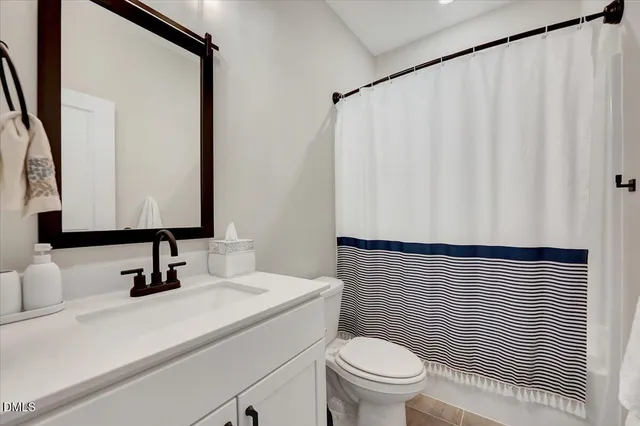a bathroom with a double vanity sink mirror and shower