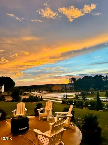 a view of a house with swimming pool and sitting area