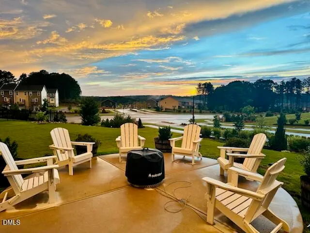 a view of a lake with lawn chairs