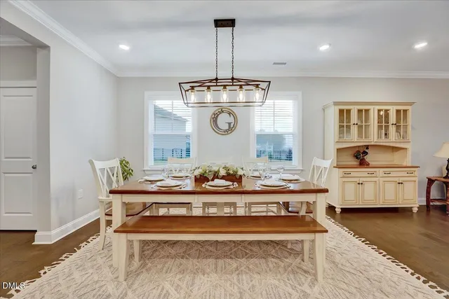 a living room with furniture kitchen view and a window